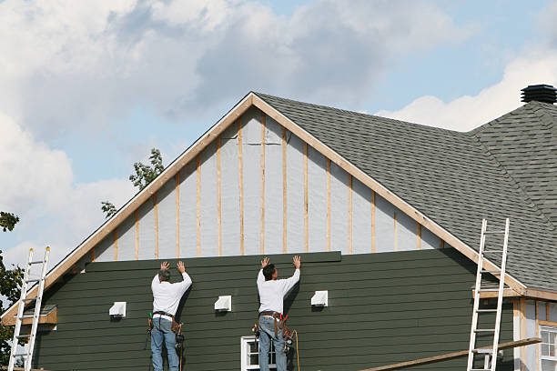 Professional Siding technician working in Fairview, NY